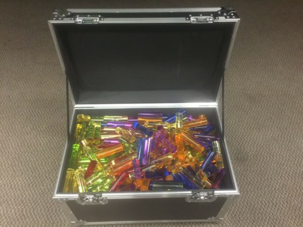 acrylic giant light bright pegs of various colors in a flight case with the lid open
